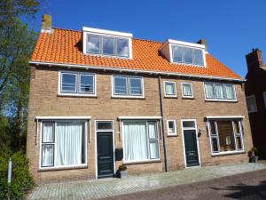 a brick house with an orange roof at Vakantiehuis in het Centrum van Domburg DO19 in Domburg