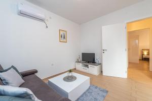 Televízia a/alebo spoločenská miestnosť v ubytovaní Star 1 modern & centrally ap for 4