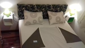 a bed with two pillows on it in a room at Apartment Biser in Kotor