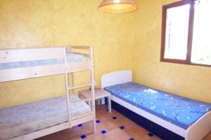 a room with two bunk beds and a window at Andre in Porto-Vecchio +13 photos