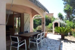 a wooden table and chairs on a patio at Andre in Porto-Vecchio
