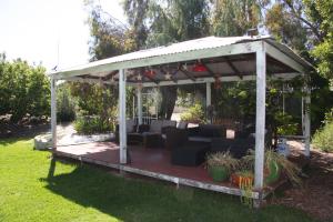 a wooden gazebo with a couch in a yard at Chuditch Holiday Home Dwellingup - Great Central Location in Dwellingup