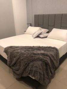 Ένα ή περισσότερα κρεβάτια σε δωμάτιο στο Asuncion Gracia Suites