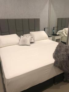 Ένα ή περισσότερα κρεβάτια σε δωμάτιο στο Asuncion Gracia Suites