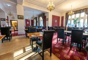 a dining room with tables and chairs at North Stafford Hotel in Stoke on Trent