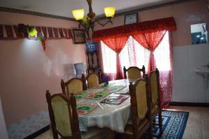 a dining room with a table and chairs in a room at BERNKISH HOMES in Nakuru