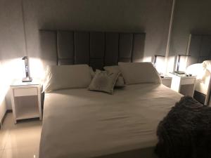 Ένα ή περισσότερα κρεβάτια σε δωμάτιο στο Asuncion Gracia Suites