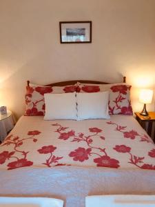 a bed with a white comforter and pillows at Aber Cottage B&B in Dolgellau
