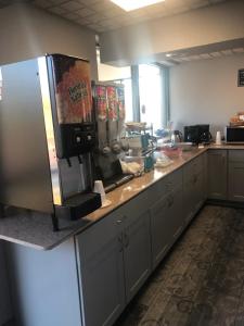 a kitchen with a large counter with a refrigerator at Travelodge by Wyndham Clarksville in Clarksville
