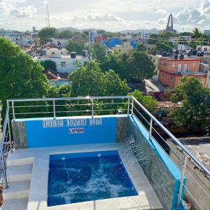 a swimming pool on the roof of a building at Higuey Center City in Higuey
