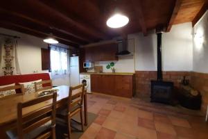 a kitchen with a table and a fireplace in a room at Lobetania in Moscardón