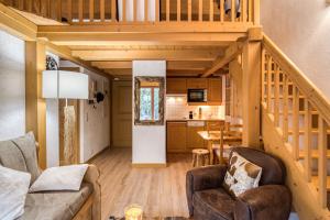 a living room with a staircase and a kitchen at Cocoon in Megeve in Megève