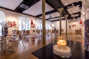 a room with a candle on a table with chairs at Ciarus in Strasbourg