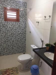 a bathroom with a toilet and a sink at Batista's Beach in Luis Correia