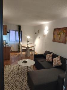 a living room with a couch and a table at Central loft at Teleferic in Sinaia