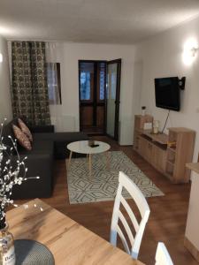 a living room with a couch and a table at Cozy loft at Teleferic in Sinaia