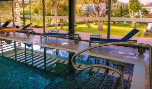a swimming pool with tables and chairs next to a swimming pool at Solar de Boaventura in Boaventura