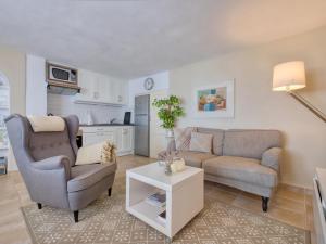 a living room with two chairs and a couch and a table at Holiday Home Petite Fleur by Interhome in Montgo +50 photos