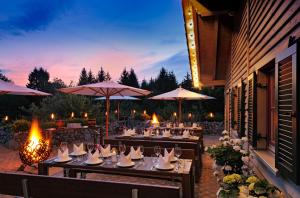 a group of tables with chairs and umbrellas at Landhotel RÖSSLE in Stimpfach