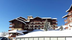 a hotel in the winter with snow on the ground at MBS b6 in Manigod