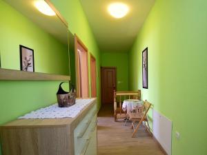 a green kitchen with a counter and a dining room at Holiday Home Bili dvori by Interhome in Čaporice