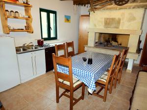 a kitchen with a table and a fireplace at Holiday Home Bili dvori by Interhome in Čaporice