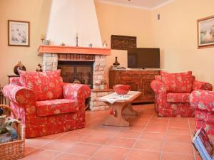 a living room with red furniture and a fireplace at Holiday Home Lea by Interhome in Rukavac
