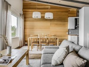 a living room with a couch and a table at Holiday Home Rukavuorenhuippu 23 b by Interhome in Ruka +32 photos