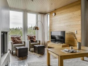 a living room with a couch and a tv at Holiday Home Rukavuorenhuippu 23 b by Interhome in Ruka