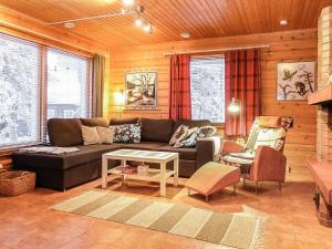 a living room with a couch and a table at Holiday Home Vuonelo by Interhome in Saariselka