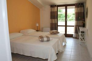 a bedroom with two beds and a window at Il Mulino Di Geminella in Narzole +59 photos