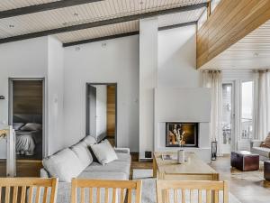 a living room with a couch and a table at Holiday Home Rukavuorenhuippu 23 b by Interhome in Ruka