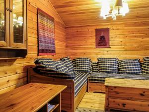 a room with couches and a table in a cabin at Holiday Home Oloskammi 5 by Interhome in Muonio