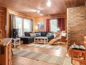 a living room with a couch and a table at Holiday Home Vuonelo by Interhome in Saariselka