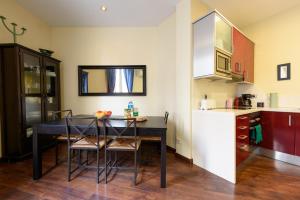a kitchen with a table and chairs in a room at RamblasRentals Design Renovated Apartment AC Balcony10m Ramblas - Parking - Wifi in Barcelona