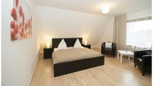 ハンブルクにあるPicklapp Apartmentsのベッドルーム1室(ベッド1台、ソファ、椅子付)