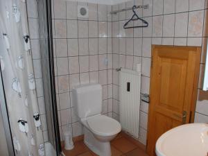 a bathroom with a toilet and a sink at Studio La Bergerie by Interhome in Ocourt