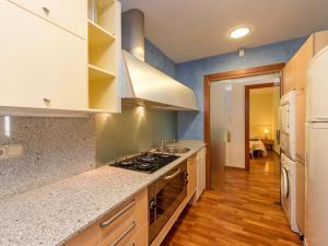 a kitchen with white cabinets and a stove top oven at Apartment Plaza Catalunya-Rda-Universidad by Interhome in Barcelona