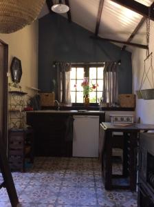 a kitchen with a sink and a counter top at Unique Tiny House with Natural Building Techniques in Figueiró dos Vinhos