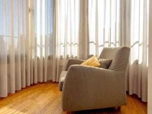 a living room with a chair and a large window at Apartment Plaza Catalunya-Rda-Universidad by Interhome in Barcelona