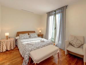 a bedroom with a bed and a chair and a window at Apartment Plaza Catalunya-Rda-Universidad by Interhome in Barcelona