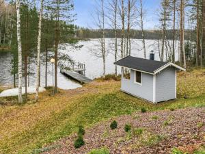 a small house on the shore of a lake at Holiday Home Rinteelä by Interhome in Heinävesi