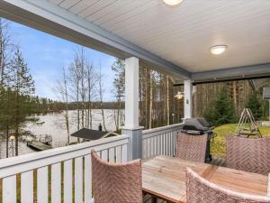 HeinävesiにあるHoliday Home Rinteelä by Interhomeの湖の景色を望むポーチ(テーブル、椅子付)
