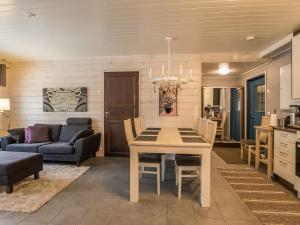 a kitchen and living room with a table and chairs at Holiday Home Hil-lak-ka ii as 5 by Interhome in Äkäslompolo