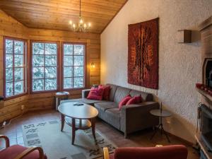a living room with a couch and a table at Holiday Home Vaarapirtti - tähti by Interhome in Lahdenperä