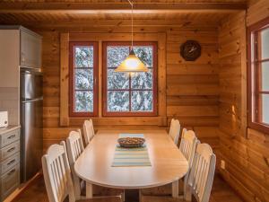 a dining room with a table and chairs at Holiday Home Vaarapirtti - tähti by Interhome in Lahdenperä +31 photos