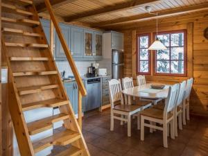 a kitchen and dining room with a table and chairs at Holiday Home Vaarapirtti - tähti by Interhome in Lahdenperä