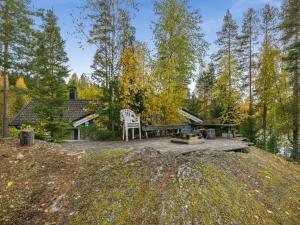 a picnic table and a white chair on a patio at Holiday Home Harrila by Interhome in Huuhanaho