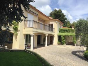 a large house with a balcony on a driveway at Luxurious sea view villa in Saint Paul de Vence in Saint-Paul-de-Vence