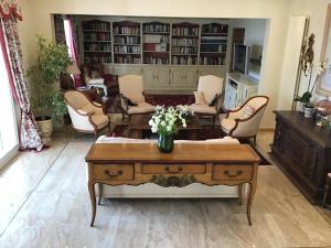 a living room with a vase of flowers on a coffee table at Luxurious sea view villa in Saint Paul de Vence in Saint-Paul-de-Vence